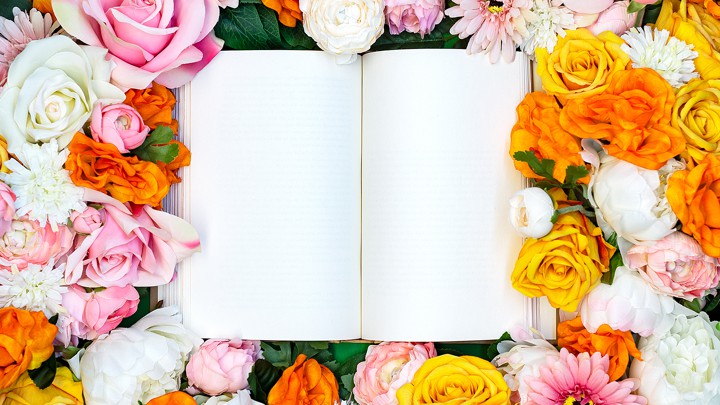 Open book surrounded by flowers