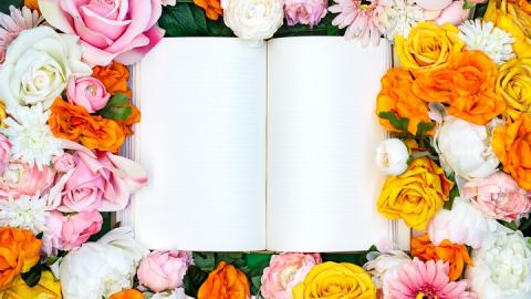 Open book surrounded by flowers