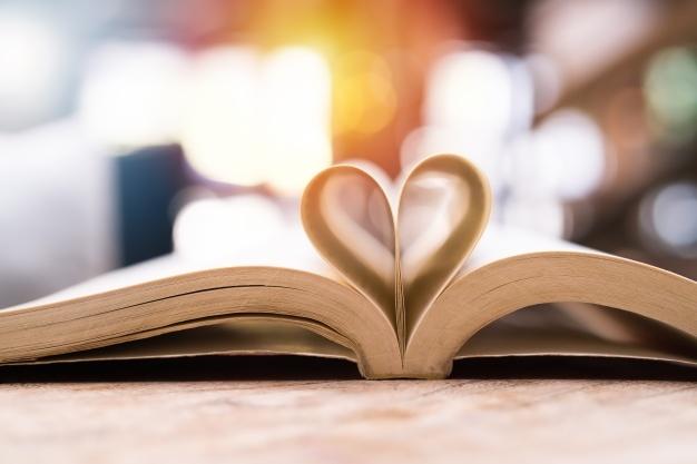 Open book with pages folded into a heart